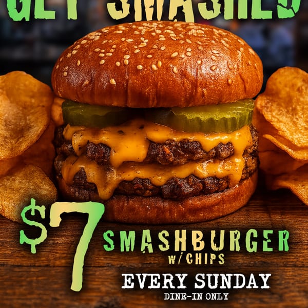 A double smashburger with melted cheese, pickles, and a side of potato chips.