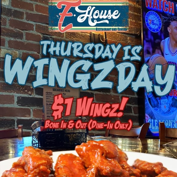 A plate of buffalo wings with a sign advertising "Thursday is Wingzday, $1 Wingz!" at Eddington House.